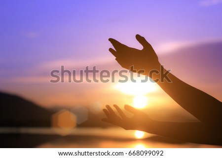 Woman praying and enjoying nature on sunset background, hope concept / soft focus picture 