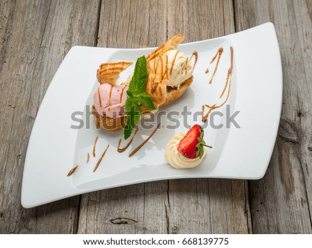 Ice cream with berries and fruits on the plate