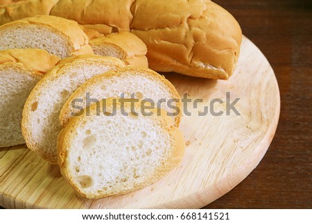 fresh bread slide on wood cutting board