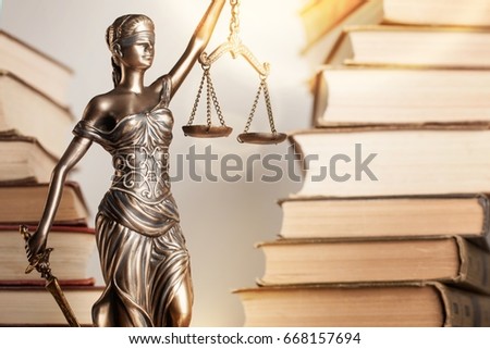 Statue of justice and book.