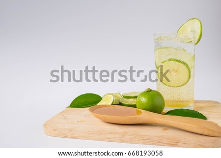 A glass of lemonade, honey, soda in a white background. Royalty-Free Stock Photo #668193058