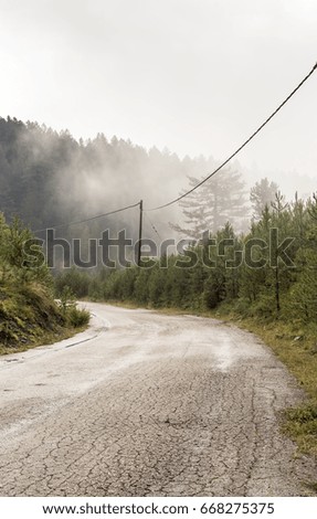 Rain and fog on the old mountain road in the countryside 