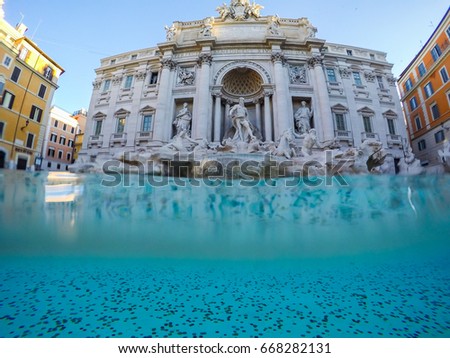 Underwater view at Trevi Fountain Rome. Coins in clear water of Trevi Fountain in Rome, Italy. The tradition of throwing coins into fountain.Background Royalty-Free Stock Photo #668282131