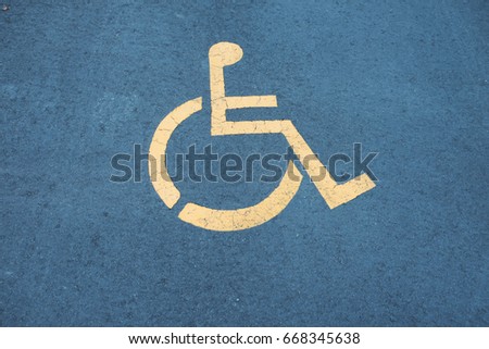 Sign place for the disabled on the asphalt.