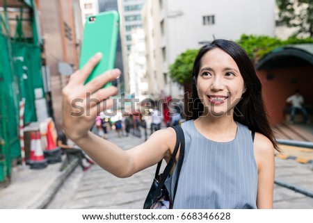 Woman taking selfie in Pottinger Street