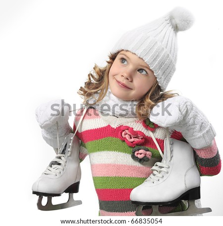 cute little girl in warm hat and gloves with figure skates on white background