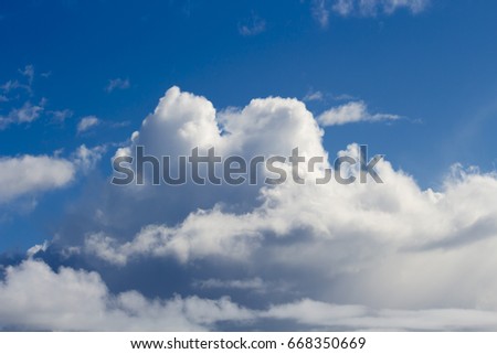 White fluffy, woolly cumulus clouds in a blue Australian sky in mid- winter  indicate fine weather for the present.