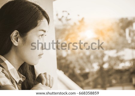 a lovely lonely woman standing looking to something with loneliness
