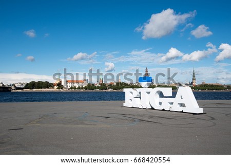Riga City name in a beautiful summer day. Riga is capital of Latvia. AB Dambis (AB Jetty)-narrow land strip in the middle of the Daugava River. One of the most popular recreational areas in the summer
