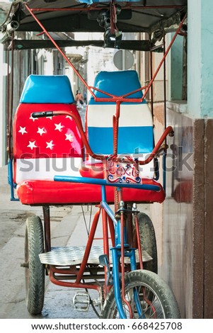 Bicycle taxi in Havana Cuba decorated with a version of the American flag