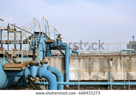 Industrial space with lots of pipes and communications on a background of blue sky. old water treatment plant on the city's water supply enterprise. Kharkov, Ukraine