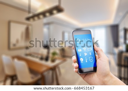 mobile phone with apps on smart home in modern dining room Royalty-Free Stock Photo #668453167