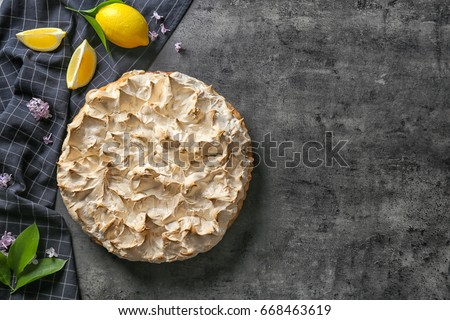 Composition with tasty lemon meringue pie on dark table