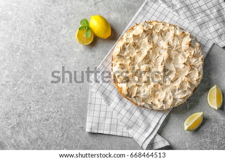 Composition with tasty lemon meringue pie on grey table