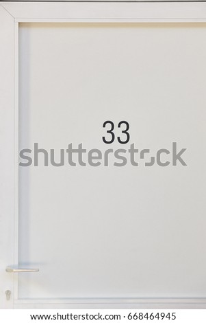 White motel room detail with number. Tourist apartment. Vacation background 