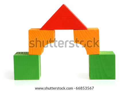 House made from children's wooden building blocks on a white background
