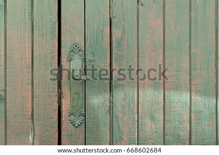 Old dark wooden door with old iron handle