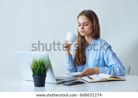 Young woman working at the computer at the desk in the office.