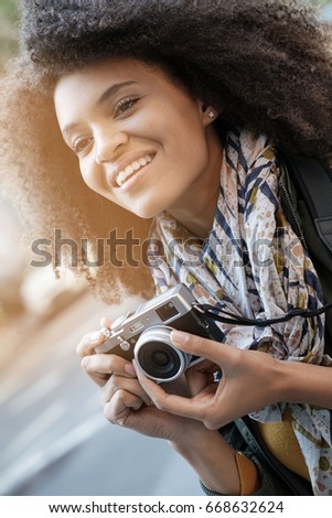 Trendy girl in New York City taking pictures with camera        