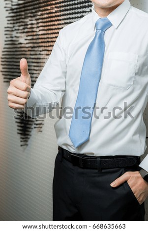 Business hands showing thumbs up sign against