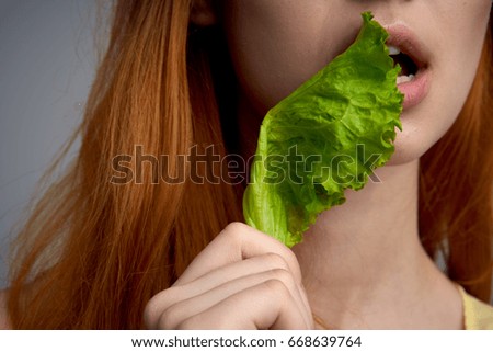 Woman with a salad leaf                                                