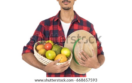 Midsection of farmer holding a basket of fruits (orange, manga, avocado and khaki) isolated in white background