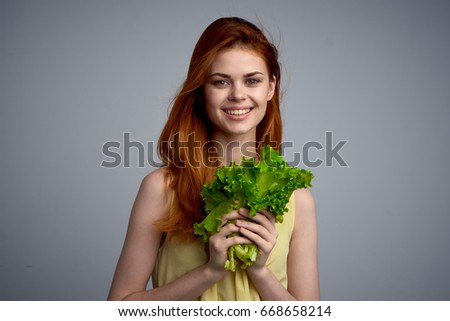 Woman with lettuce leaves                               