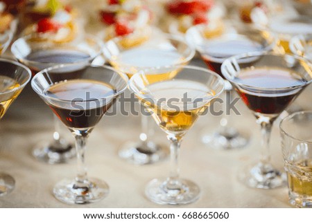 Martini glasses with white and red cocktails