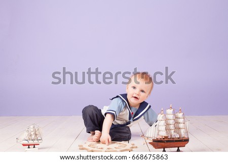a little boy dressed as a sailor captain of ship