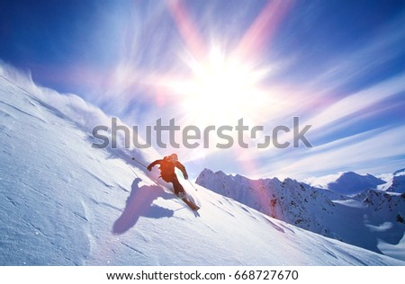 Full length of skier skiing on fresh powder snow