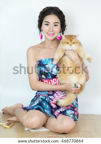 Beautiful women with cats eating cat food