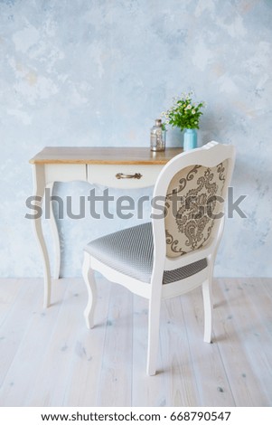 Classic console and chair in a gentle interior pastel colors. blue painted wall