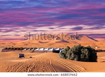 Camp site with tents over sand dunes in Merzouga, Sahara desert, Morocco, Africa Royalty-Free Stock Photo #668819662