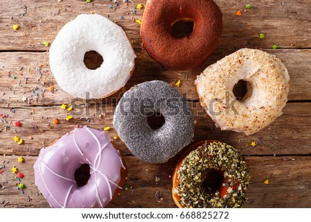 Fresh donuts with frosting close-up on the table. horizontal view from above
