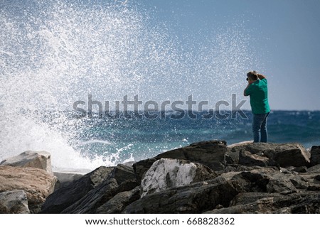 people taking pictures of Sea Storm and tempest on the coast