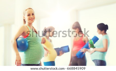 pregnancy, sport, fitness, people and healthy lifestyle concept - happy pregnant woman with ball in gym