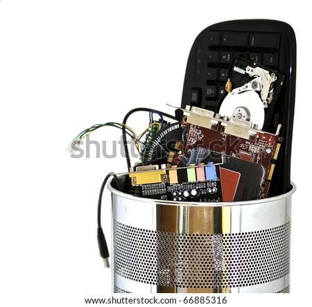 Metal trash can containing computer waste isolated on white background