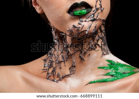 Neck details of creative fashion make up on black background in studio photo. Cosmetics and extravagant makeup