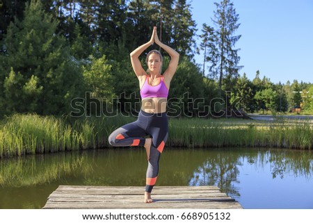 A sporty woman doing yoga and stretching exercises