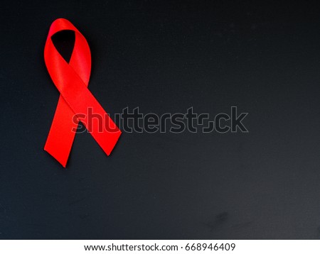 World AIDS day concept. red ribbon on black background.
