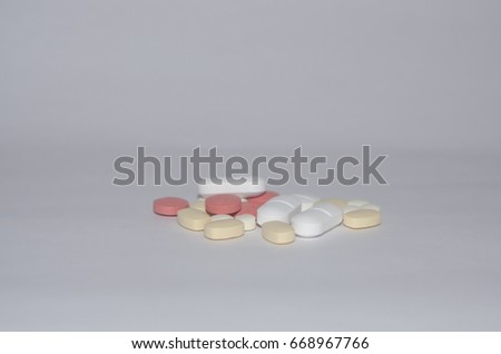 
Pills of various medications on white background
