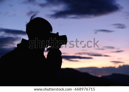 silhouette man taking photos  with camera