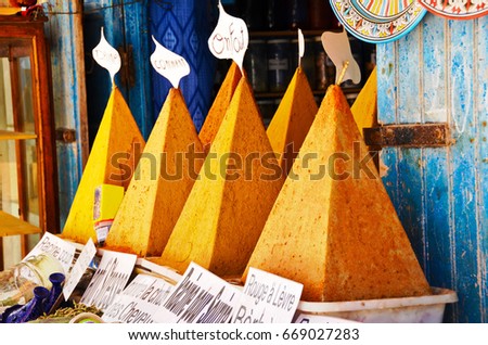the inscriptions on the pictures in English - ginger root, pepper, red lips, brown,curry,cinnamon . Pyramids of spices at the Bazaar in Morocco,ginger root, pepper red lips, brown,cinnamon