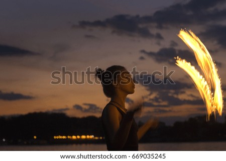 Fire Performer -  sunset fire dancing  at the beach