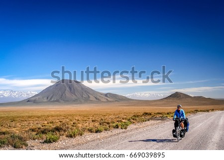 Woman cycling on the famous national Ruta Quarenta in the remote part of central Argentina