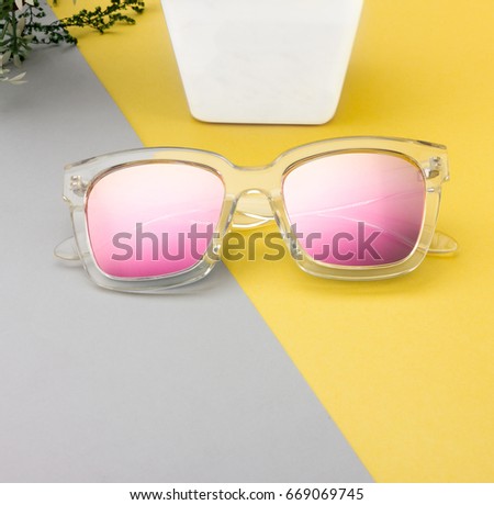 CREATIVE SHOOT OF SUNGLASSES WITH COLORFUL BACKGROUND AND COOL PROPS.