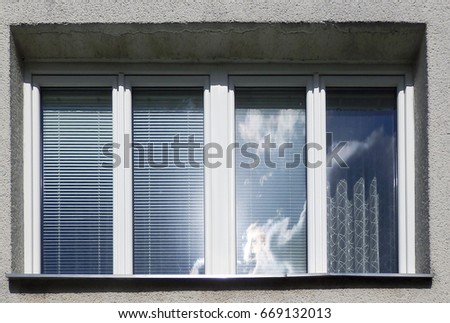 color detail photography of family house window with clouds and sun reflection
