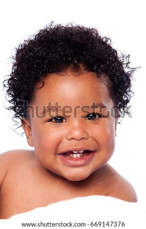 Happy smiling cute adorable teething baby face showing milk teeth, with curly hair. Royalty-Free Stock Photo #669147376
