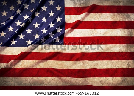 Waving star and striped United States of grunge America flag.Studio shot