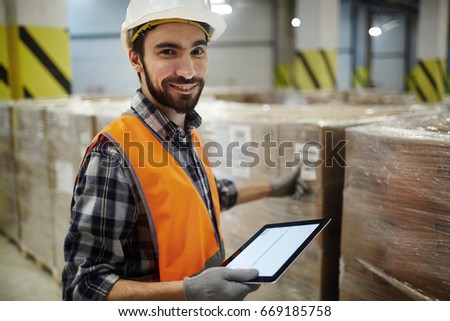 Successful warehouse staff sorting packed goods Royalty-Free Stock Photo #669185758